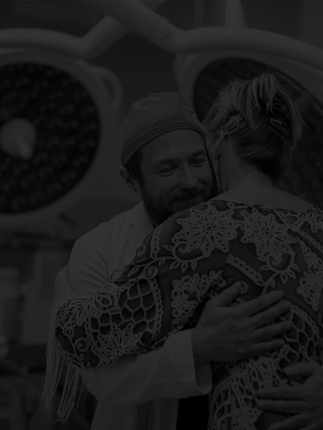 Doctor and patient embrace in heartfelt moment.