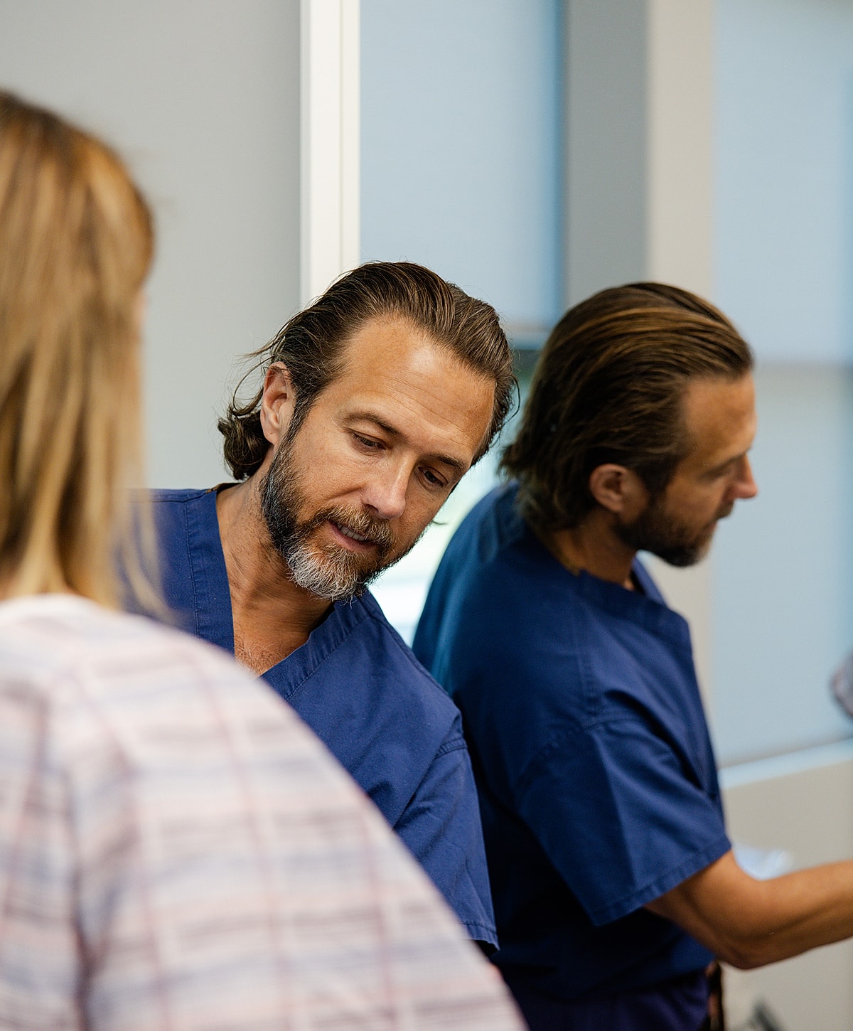 Doctor consulting with patient in medical setting.