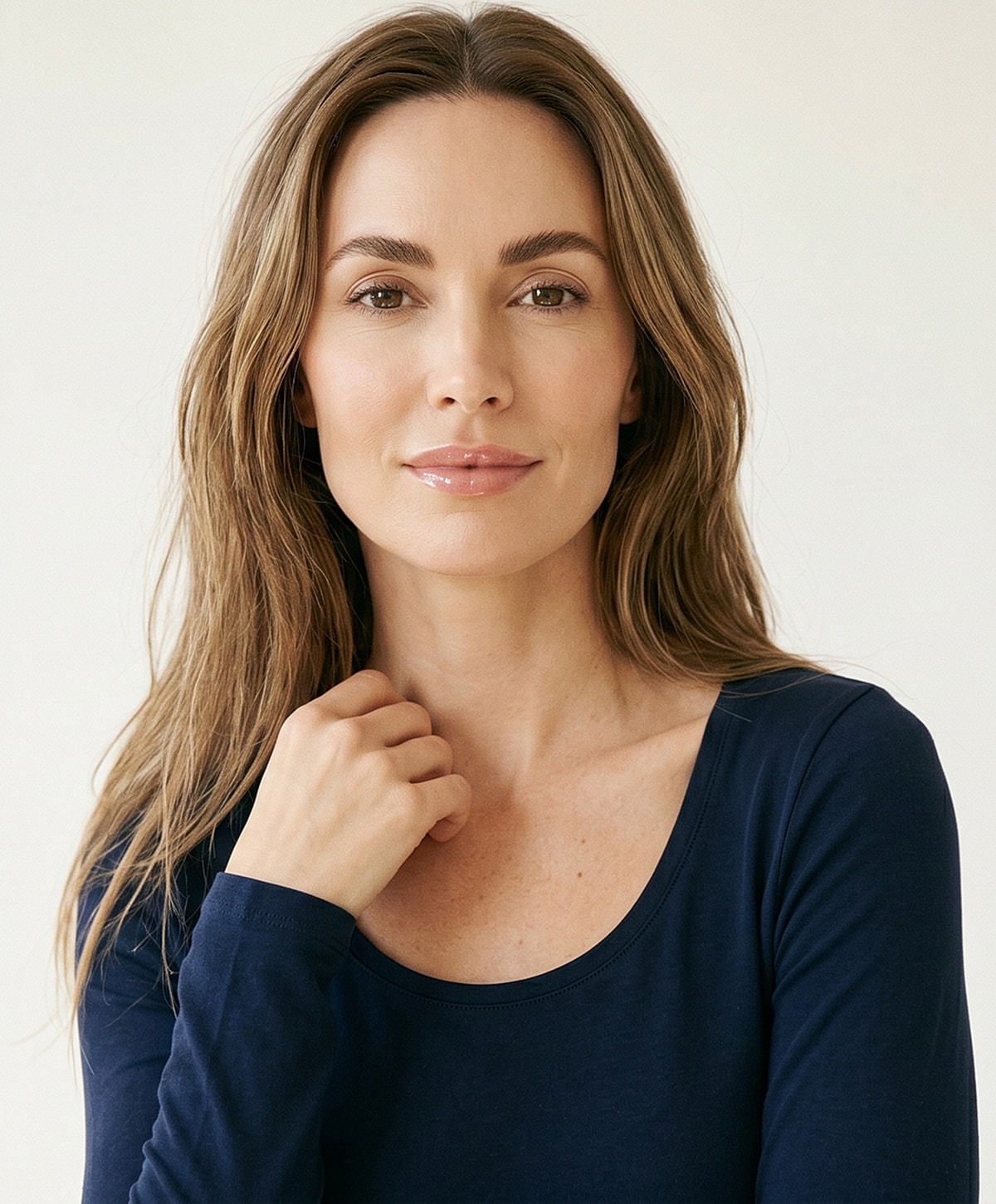 Woman with long hair in navy top.