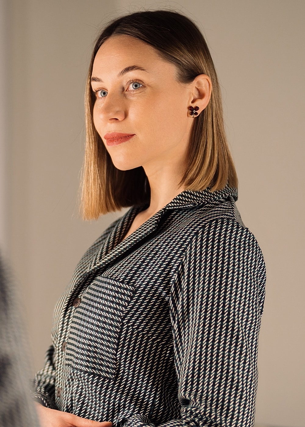 Smiling woman with long wavy blonde hair.