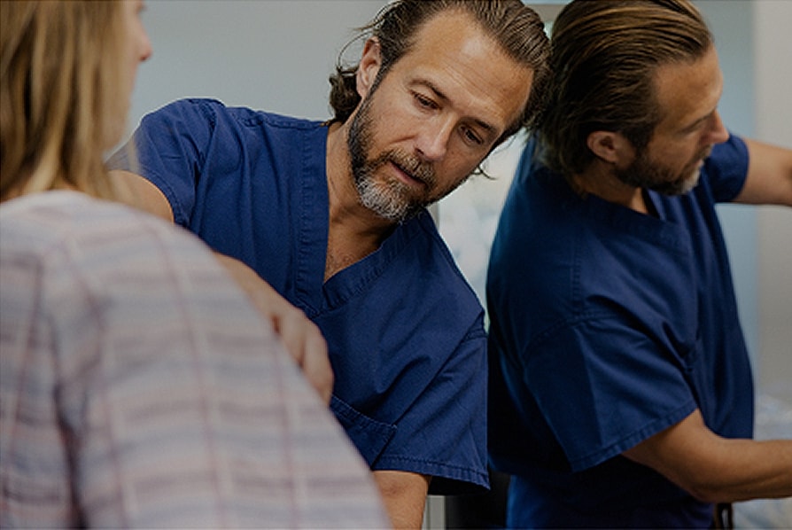 Medical professionals assisting a patient with care.