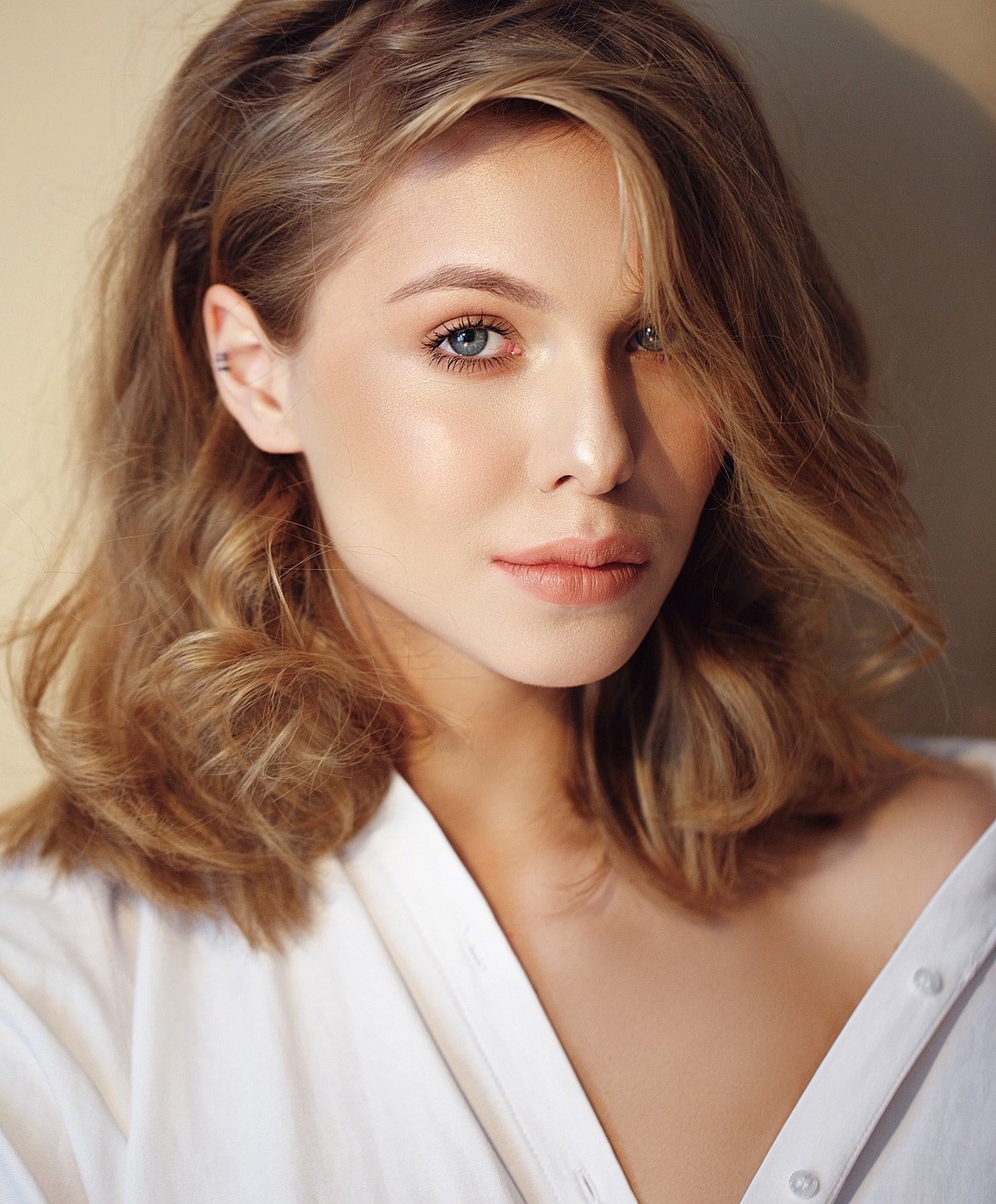 Close-up portrait of a woman with wavy hair.